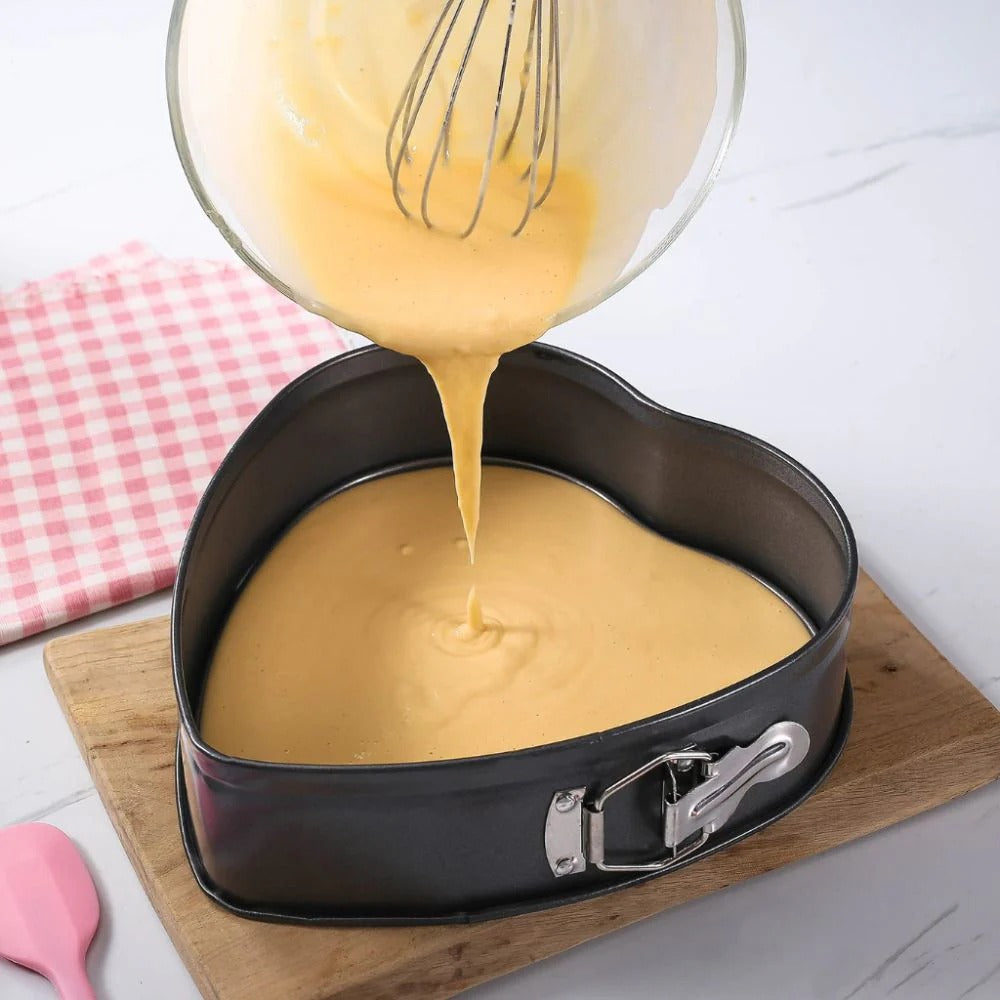 Heart-shaped nonstick cake mold with baked dessert